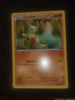 Photo of a Larvitar Pokemon trading card, mint condition, showing front artwork and details.