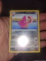 Front view of the Lickilicky Reverse Holo Pokemon card held in hand, showing holographic background and card details.
