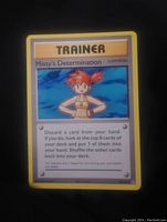 Clear image of Misty's Determination Trainer card showing artwork and card text, yellow border framing the card.