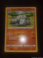 Photo of the front side of the Onix Pokemon card showing the illustration and details.