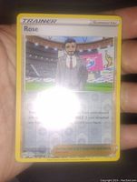 Clear image of the Rose Trainer Pokemon card showing character in a suit, with reverse holographic finish.