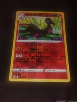 Photo of a single holographic Salazell Pokemon card showing front side with details of moves and attributes.