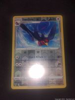 Front photo of Swellow holo foil Pokémon card showing artwork, attacks, and card details with some reflection glare.