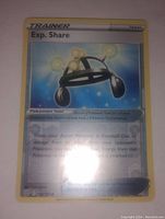 Clear front image of the Exp. Share Trainer Holo card showing the holo helmet image and text details