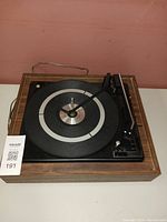 Full view of BSR 5900x vintage record player showing wooden casing, turntable, tonearm, and controls.