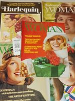 Photo showing 5 vintage magazines stacked, featuring Harlequins Woman and Harlequin titles with illustrated and photographic covers including festive themes and portraits