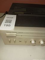 Front close-up showing Harman Kardon PM640 branding, part of the control panel with power switch and input selectors.