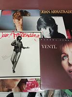 Photo showing a selection of record album covers including Joan Armatrading, Debby Boone, and Barbra Streisand Yentl soundtrack.