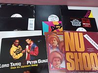 Lot of used 12 inch vinyl records with various artists and colorful covers.