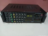 Front view of SOKE MS 3000 digital mixing amplifier showing control knobs, inputs, EQ sliders, and power indicator light.