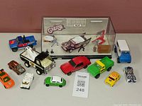 Overview of all diecast toy vehicles including Tonka trucks, Hot Wheels cars, and Grease diorama model