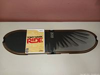 Tony Hawk RIDE balance board with Wii game case on top