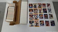 Top view of two long boxes filled with neatly stacked 1990-91 Upper Deck and Proset hockey cards. Cards are faced up showing various players including Wayne Gretzky, Mario Lemieux, Brett Hull, Ray Bourque, and Mark Messier.