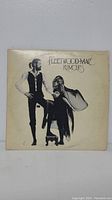 Front cover of Fleetwood Mac Rumours LP album showing band members in black and white photo.