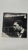 Front cover of John Coltrane A Love Supreme vinyl LP with photo of Coltrane.