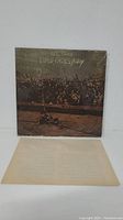 Front cover of the vinyl LP album 'Time Fades Away' by Neil Young showing concert crowd scene.