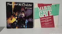 Front covers of Prince and the Revolution maxi single and Marvin Gaye maxi single shown side-by-side on a shelf.