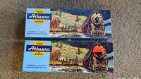 Two Athearn Trains Miniature brand boxes with locomotive images on the cover, labeled authentic and realistic