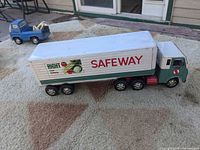 Side angle of metal Safeway semi truck toy showing trailer and cab with Safeway branding.