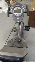 Full view of CyBex exercise bike showing seat, pedals and electronic console.