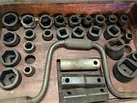 Top view showing all metal sockets and handle components arranged inside wooden tool box