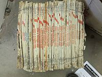 Over 50 vintage radio and television magazines stacked with visible spines showing dates and titles, bound with wire, displaying age-related wear and tear.