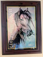 Framed horse print titled 'Unbroken Spirit' showing close-up head profile of horse with flowing mane and title text.