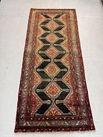 Full view of the Persian Zanjan rug showing its full length and detailed design.
