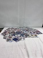 Spread of hundreds of assorted hockey cards laid out on a surface, showing various designs and players.