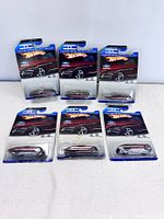 Six Hot Wheels Designer's Challenge Gangster Grin diecast cars laid out in two rows, five in sealed packaging and one with visible damage to the packaging.