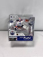 Front view of the Grant Fuhr figure in its packaging showing the figure and labeling with the Edmonton Oilers logo.