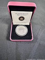 2011 Canadian Silver Coin in display case with certificate insert showing Maple Leaf Forever text.