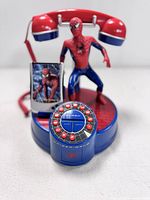 Front angle of the red and blue Spider-Man 2 themed corded rotary dial telephone featuring a crouching Spider-Man figure, rotary dial buttons and screen display.