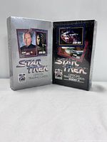 Two sealed Star Trek trading card boxes side by side, Series I in silver and Series II in black packaging.