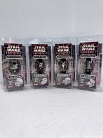 Front view of four Star Wars Episode 1 die cast watches, sealing intact, featuring Pit Droid, Darth Maul, Battle Droid, and R2-D2 characters.