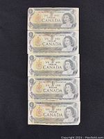 Front sides of all five 1973 Canadian $1 bills featuring Queen Elizabeth II portrait and currency details.