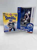 Photo of Wayne Gretzky figure box and Honey Shreddies cereal box side by side.