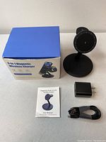 Photo of all included items: 3-in-1 magnetic wireless charging station, USB power adapter, USB cable, user manual, and box.