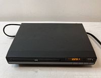 Front view of black DVD player showing DVD tray, digital time display, USB port, and control buttons