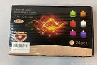 Closed box of colorful LED small night lights with packaging showing multiple color options and count of 24 pieces.