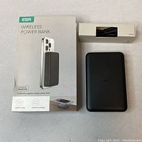 Box and contents of ESR wireless power bank with cable, showing front of box and power bank device.
