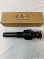 KenES branded box alongside the black threaded pop-up bathroom sink drain with overflow.