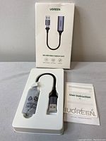 Ugreen HD USB Video Capture Card in original box with user instruction manual.
