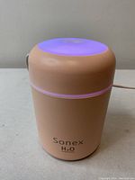 Front side view of Sonex USB Colorful Humidifier showing brand and purple LED light glowing at the top edge.