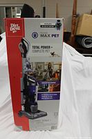 Front side of the box showing the Dirt Devil Power Max Pet upright vacuum with product images and feature highlights.