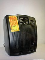 Black Goldshield Air Solution air purifier with vertical grille front, control panel at the top, and sale price sticker indicating $49.99 on the front.