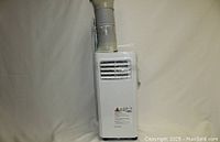 Side view of white portable air conditioner showing exhaust hose connected and air vent grilles