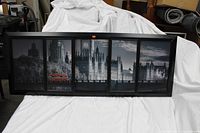 Front view of the multi-panel black framed artwork depicting Westminster Palace and Big Ben with grayscale tones and highlighted red double-decker bus