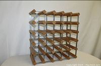 Photo of two wooden wine racks with galvanized steel reinforcements, showing grid design capable of holding 30 wine bottles.