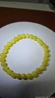 Clear image of lemon jade bracelet with round 6mm beads on a white background.